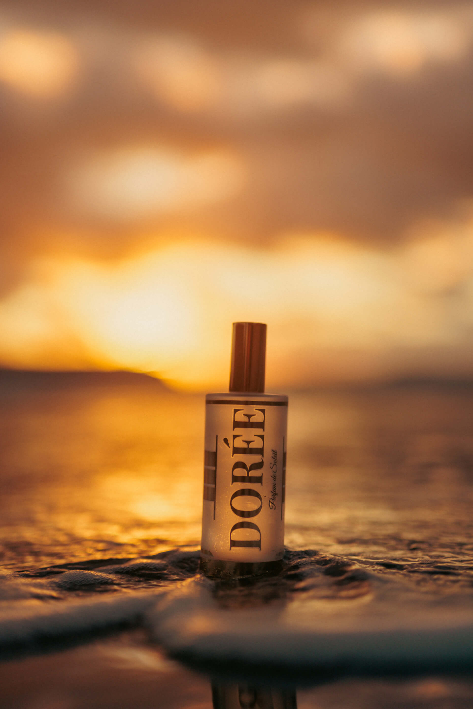 Dorée bottle in waves at sunset